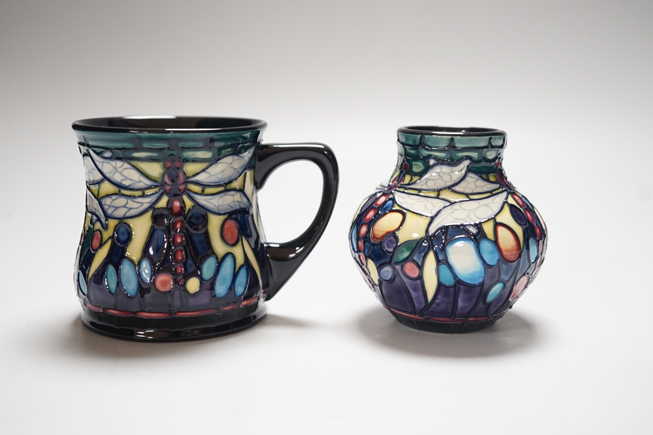 A boxed Moorcroft ‘Dragonfly’ mug and a similar vase, mug 8.5cms high